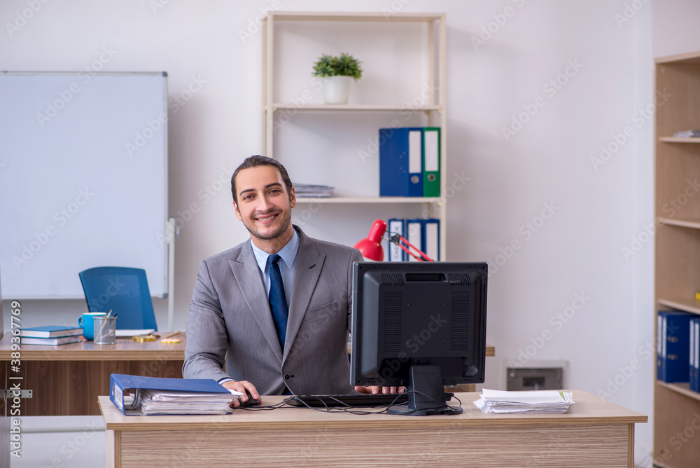 Young male businessman employee working in the office