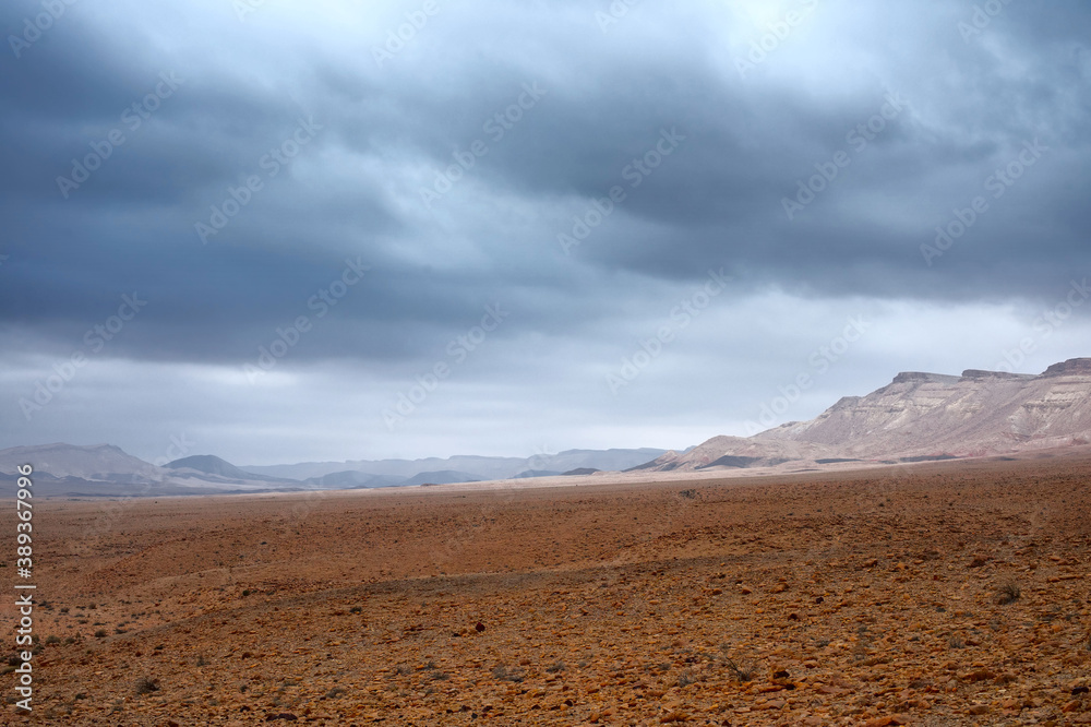 Rocky deserted landscape under a stormy sky. Rocky deserted landscape under a stormy sky.