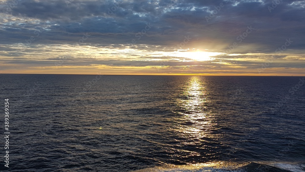 Fototapeta premium Image of a sunset on the ocean taken from a cruise ship off Norway
