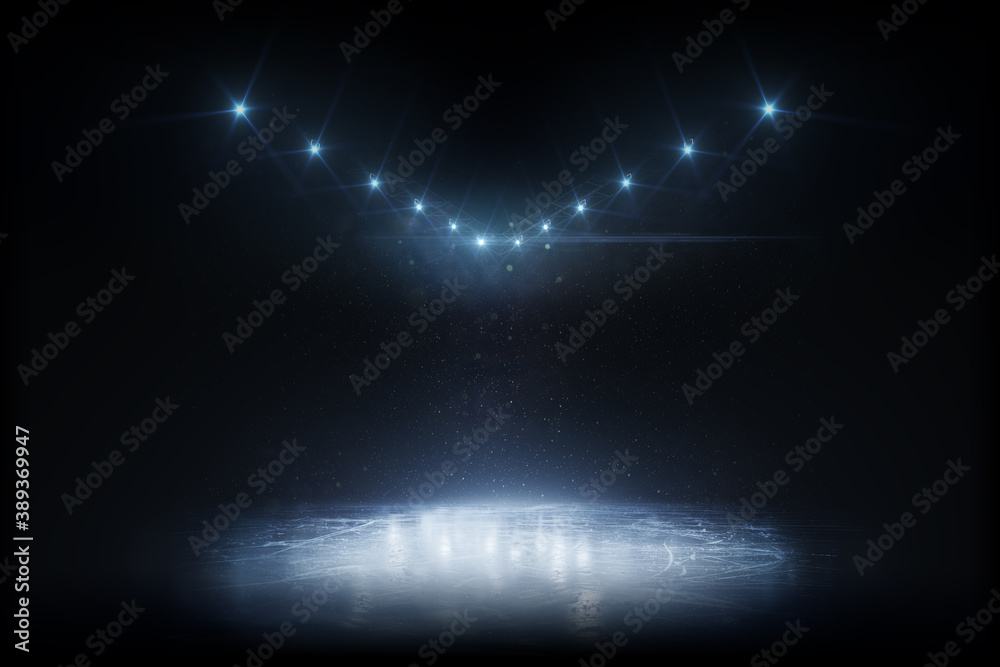 Beautiful empty winter background and empty ice rink with lights. Winter background. Spotlight shines on the rink. Bright lighting with spotlights