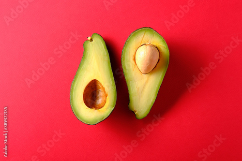 Avocado on a red background, top view