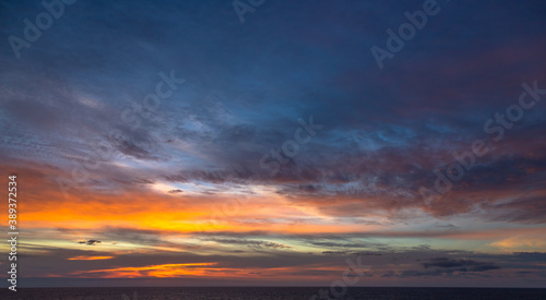Sunset and dramatic set of clouds drifting over the tropical waters of the Caribbean Sea are lit by the last moments of daylight. © Paulo