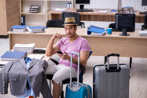 Young male employee preparing for the trip