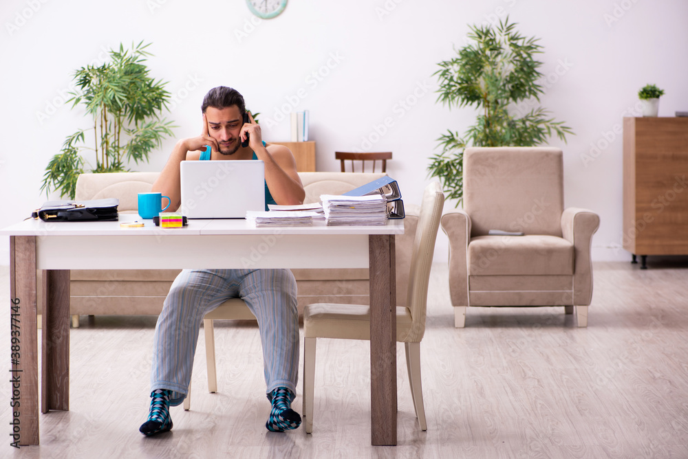 Fototapeta premium Young man working from house during pandemic