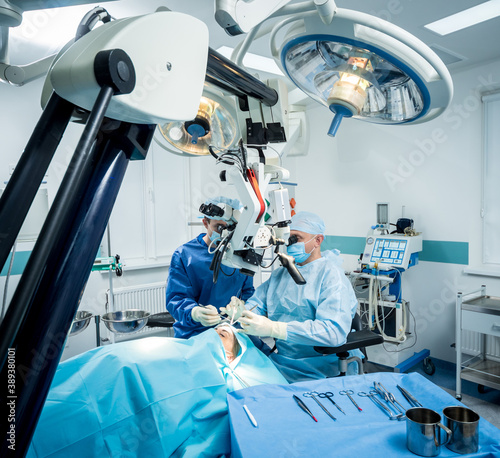 A team of surgeons performing brain surgery to remove a tumor. photo