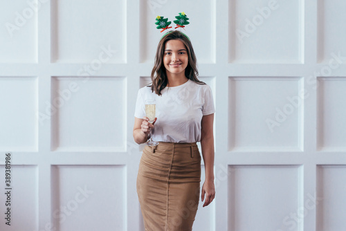 Portrait of young woman with glass celebrate Christmas or New Year