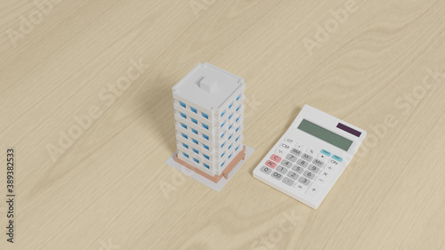 Calculator with a toy apartment placed on a plane.