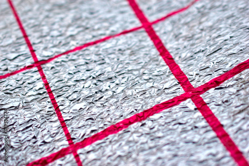 Silver thermal insulation material with red stripes