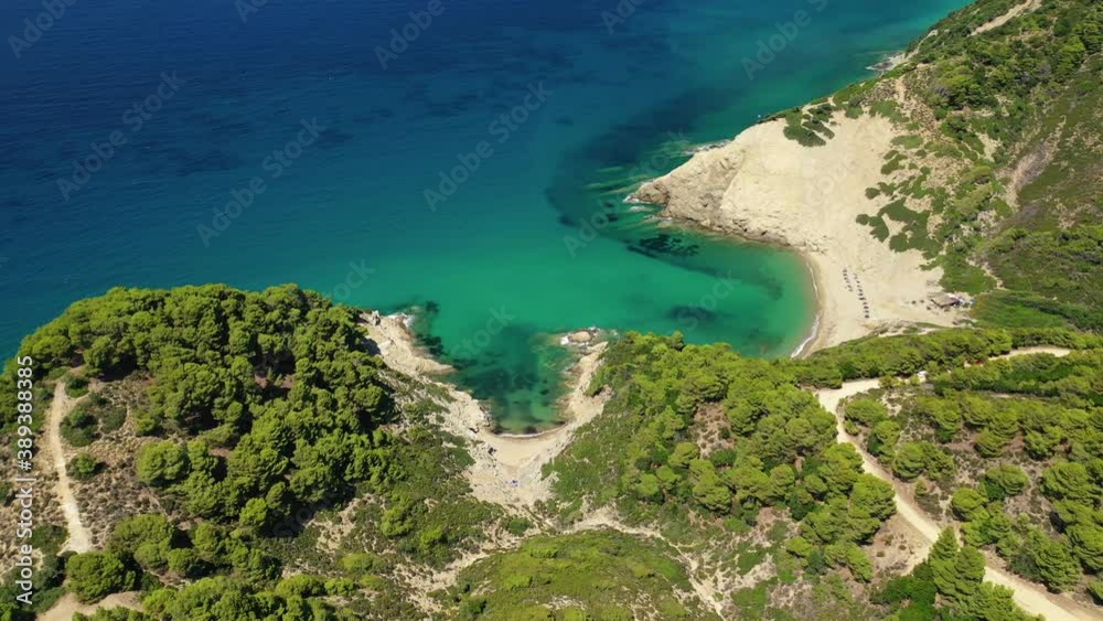 Aerial drone video of paradise emerald and turquoise sandy beach of Aselinos covered in pine trees in island of Skiathos, Sporades, Greece Aerial drone video of paradise emerald and turquoise sandy beach of Aselinos covered in pine trees in island of Skiathos, Sporades, Greece