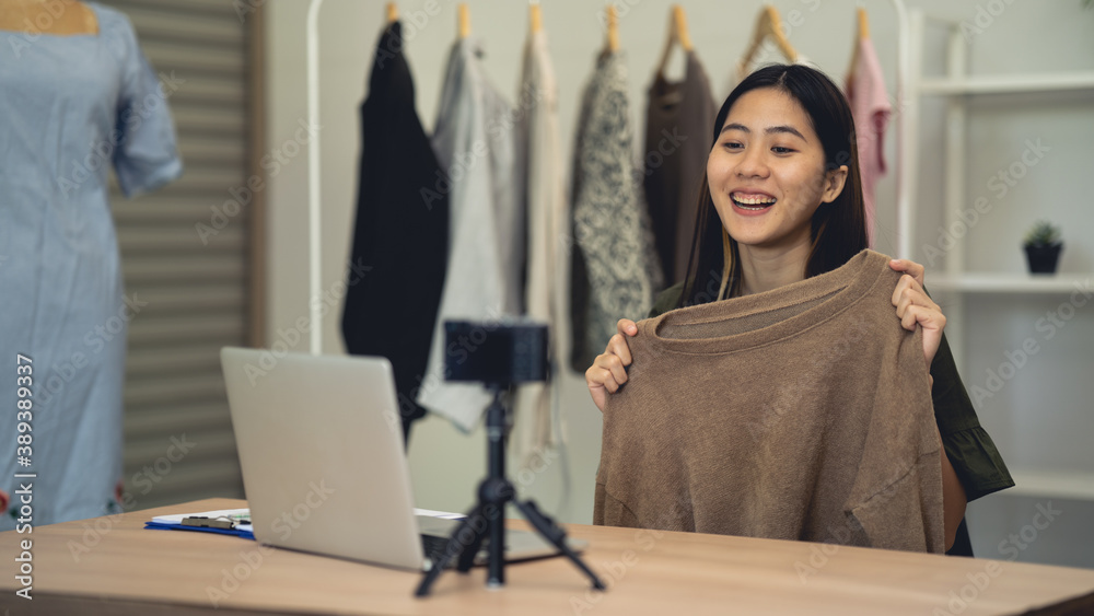 Asian women are broadcasting live online. Work at home. Selling clothes online.