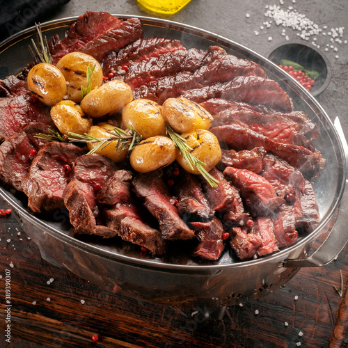 Hot Mix of grilled steaks on a plate with potatoes and rosemary