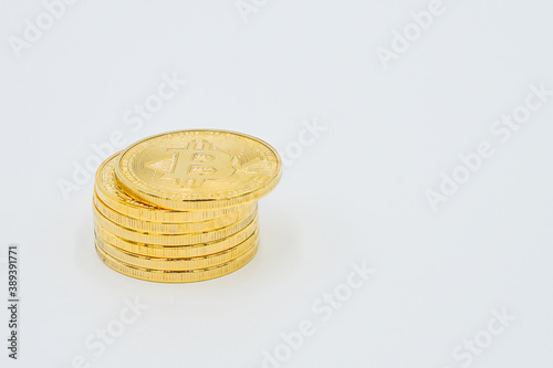 Close Up Shot of Golden Bitcoins on a white Background: Future Currency - fincance concept - free white space photo