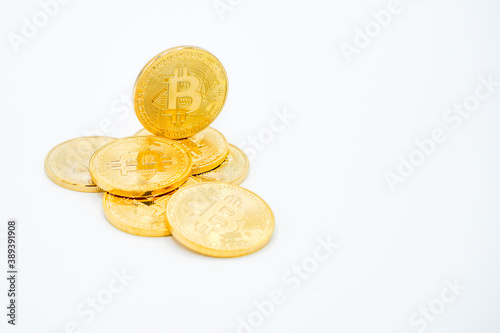 Close Up Shot of Golden Bitcoins on a white Background: Future Currency - fincance concept - free white space photo