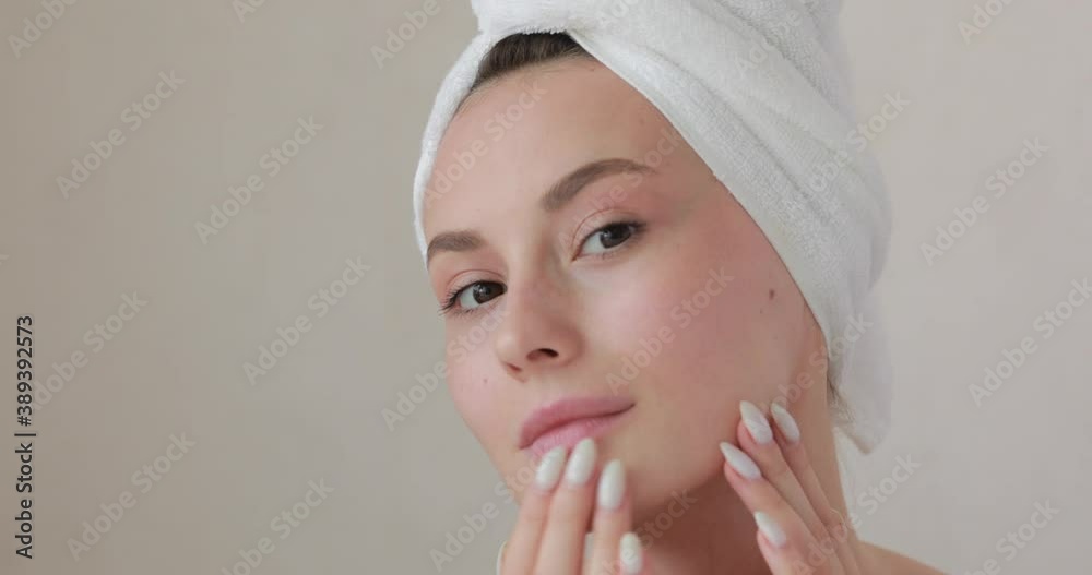 Attractive model enjoying her fresh pure skin after morning procedures. Young woman touching face with fingers. Spa treatment and wellbeing concept. Attractive model enjoying her fresh pure skin after morning procedures. Young woman touching face with fingers. Spa treatment and wellbeing concept.