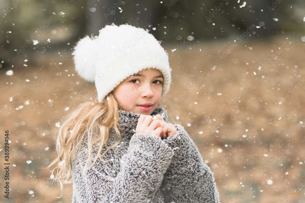 Pretty young girl portrait in winter nature. Girl with white cap and furry sweatshitr is cold and snowing. Winter and cold concept with copy space. Pretty young girl portrait in winter nature. Girl with white cap and furry sweatshitr is cold and snowing. Winter and cold concept with copy space.