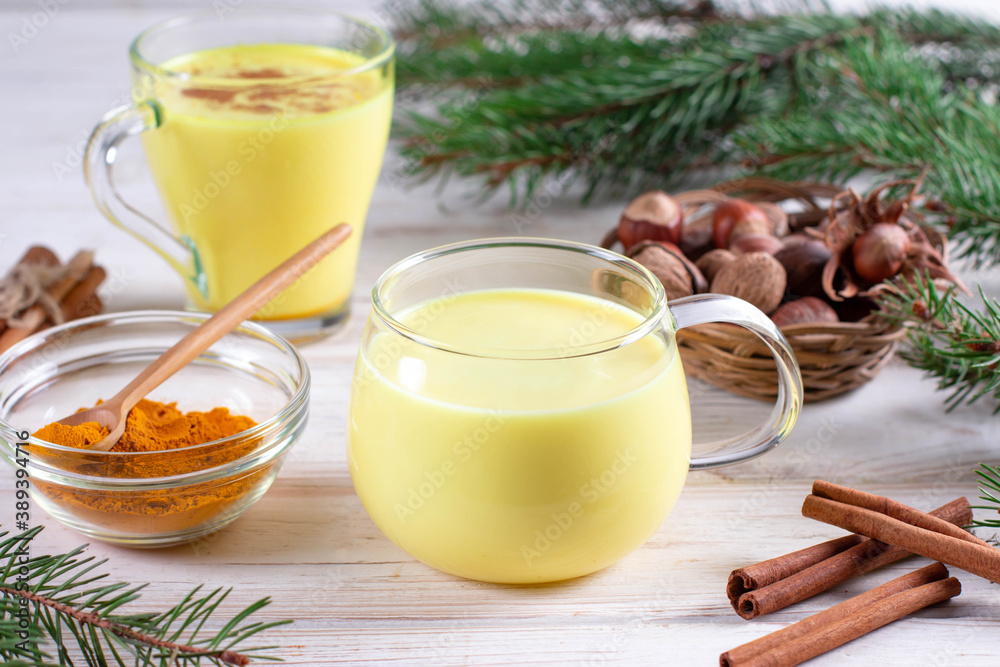 Healthy vegan golden milk, turmeric root, ginger powder, cinnamon on white background. Spices for ayurvedic treatment. Healthy vegan golden milk, turmeric root, ginger powder, cinnamon on white background. Spices for ayurvedic treatment.