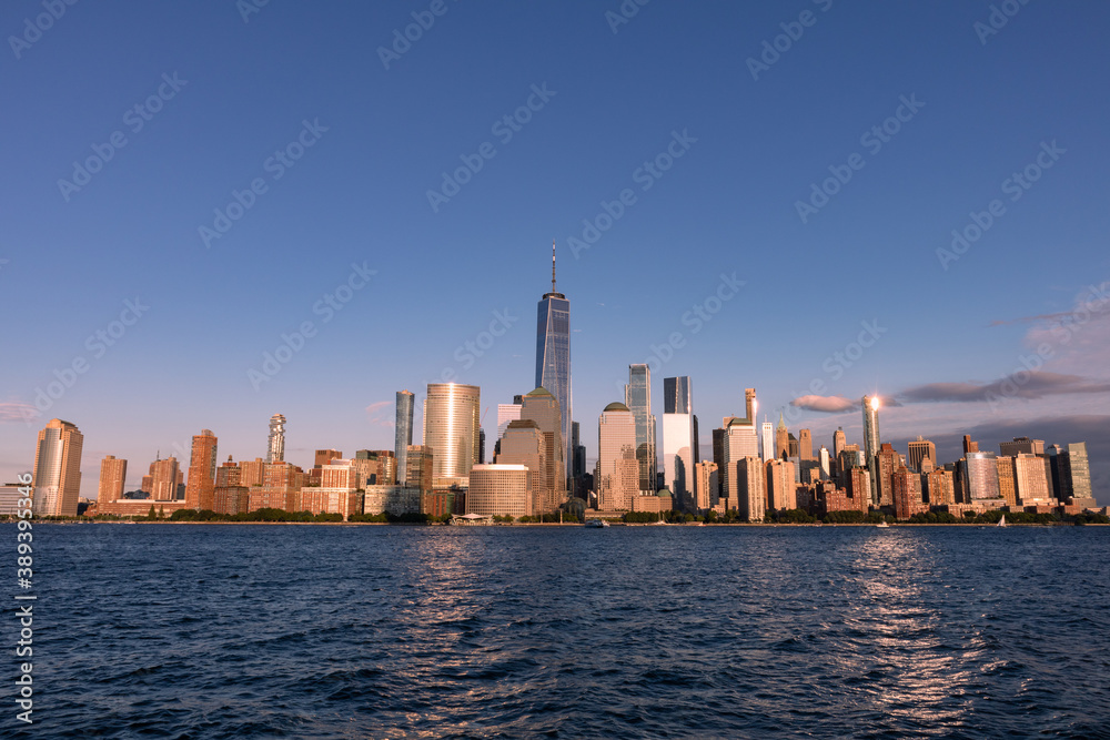 Lower Manhattan Skyline along the Hudson River in New York City Shining during a Sunset