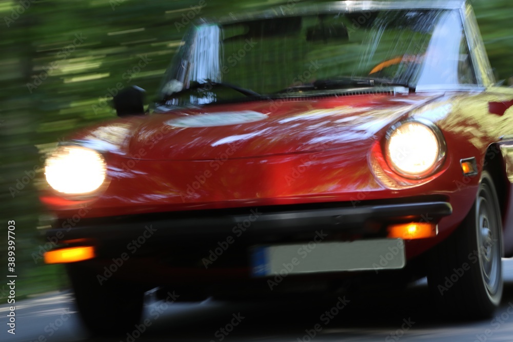 Red cabrio oldtimer in fast motion