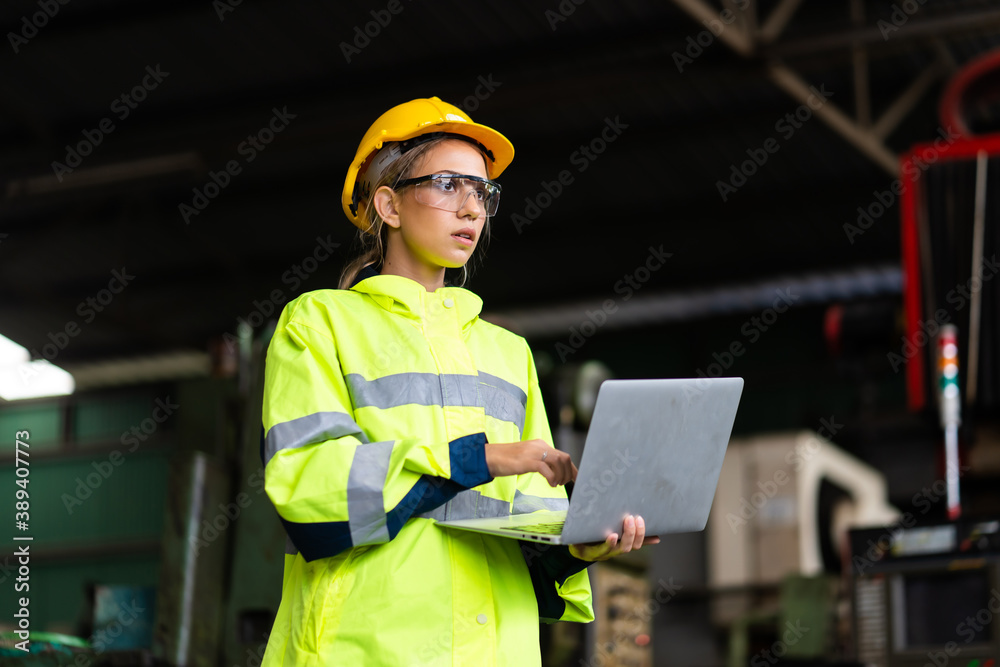 Female Quality control inspector checking workers at factory. Woman ...