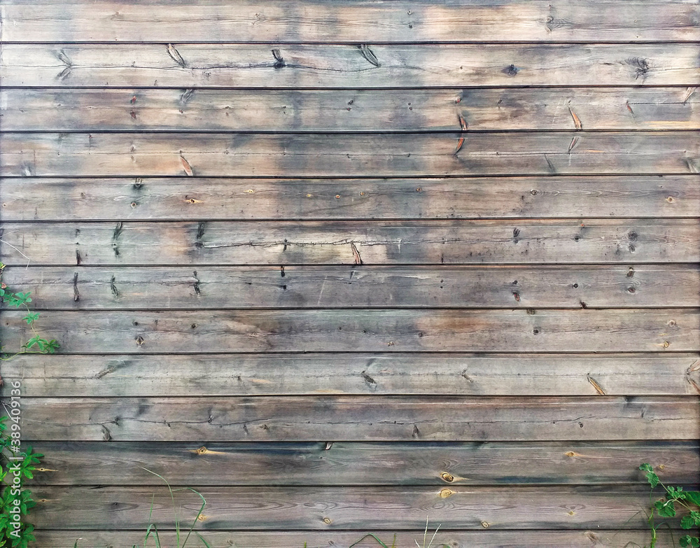 Wall background of horizontal old wooden slats in natural state. Exterior wall or fence of wooden planks. Detail of Caribbean architecture, tropical construction. Wood background.