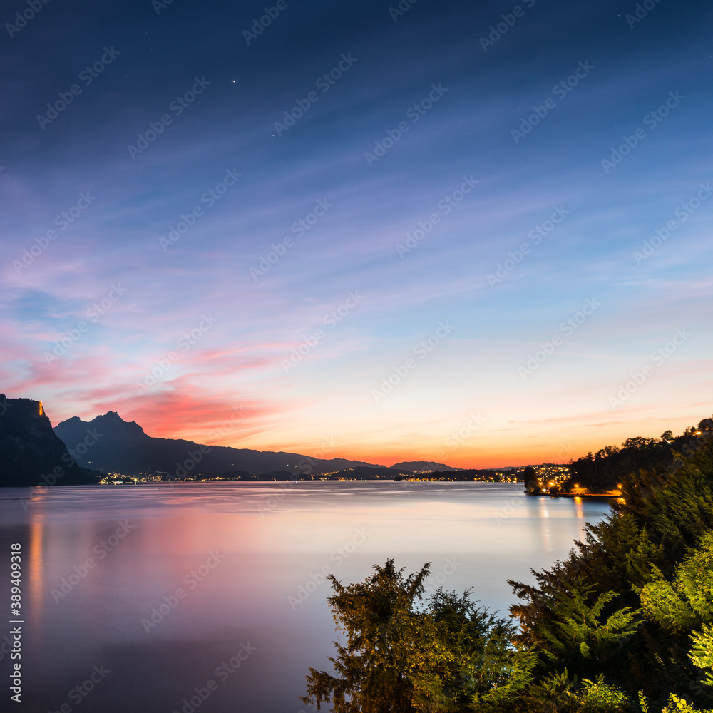A magnificent sunset over Lake Lucerne. City lights. Top of Mount Pilatus. Switzerland.