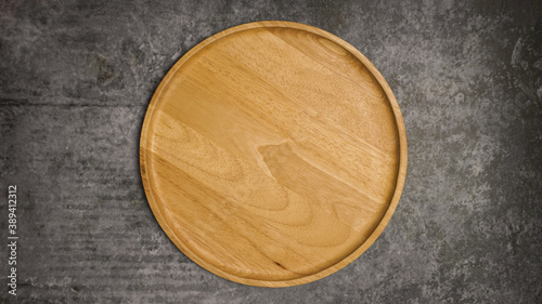 Wooden dish on gray cement table.