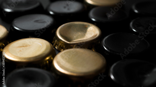 beer lids on a dark surface
