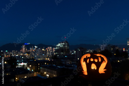 Ghost carved pumpkin with a city view background