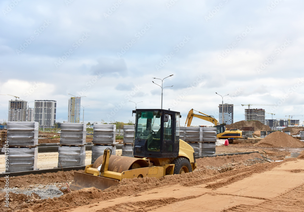 Vibro Roller Soil Compactor leveling ground at construction site. Vibration single-cylinder road roller on construction road. Road work for new asphalt laying. Excavator digs ground