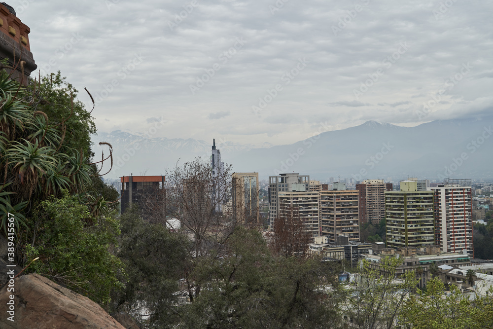 view on the sub urban city scape of santiago de chile with sky scrapers and  the andean mountains in the hazy background_2