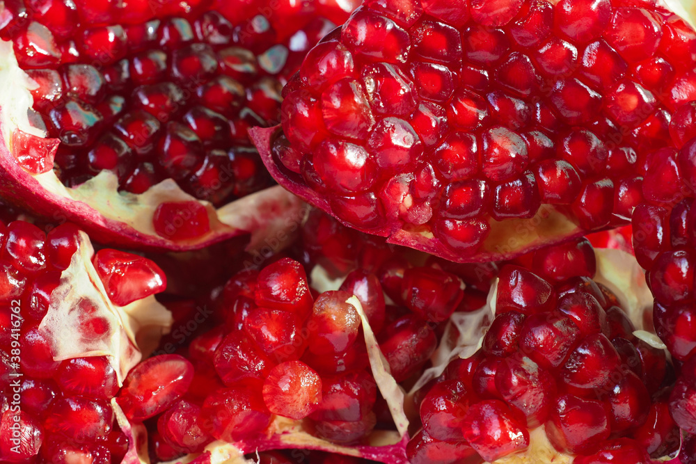 Slices ripe pomegranate, garnet background. Punica granatum, harvest Slices ripe pomegranate, garnet background. Punica granatum, harvest