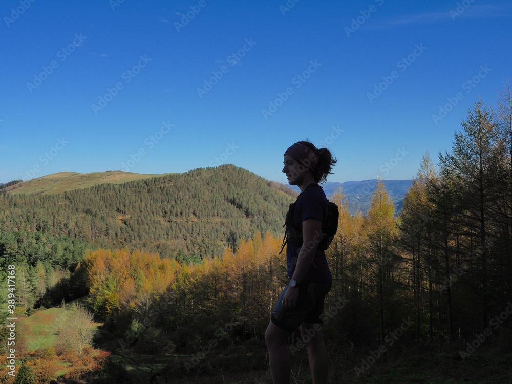 young woman with a mountain background in autumn