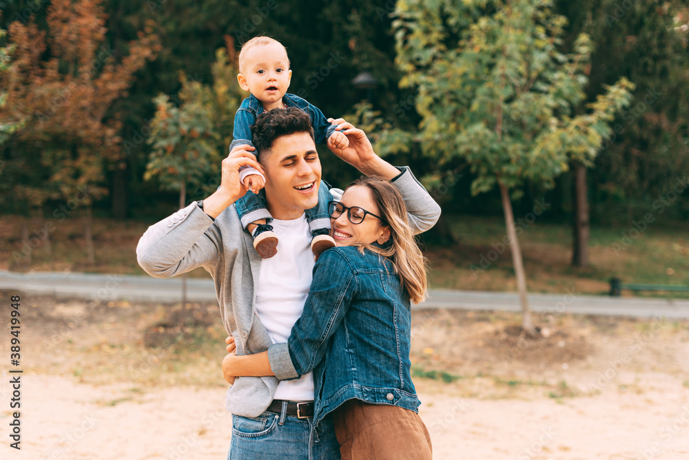 Fototapeta premium A beautiful portrait of a young family in park .
