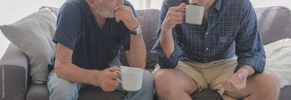 Φωτογραφία Half portrait of two old father and son family relax talking and drinking coffees at sofa living room warmth house on holiday