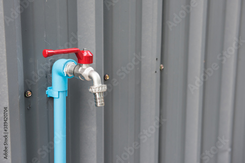 steel water faucet or tab at metal zinc wall
