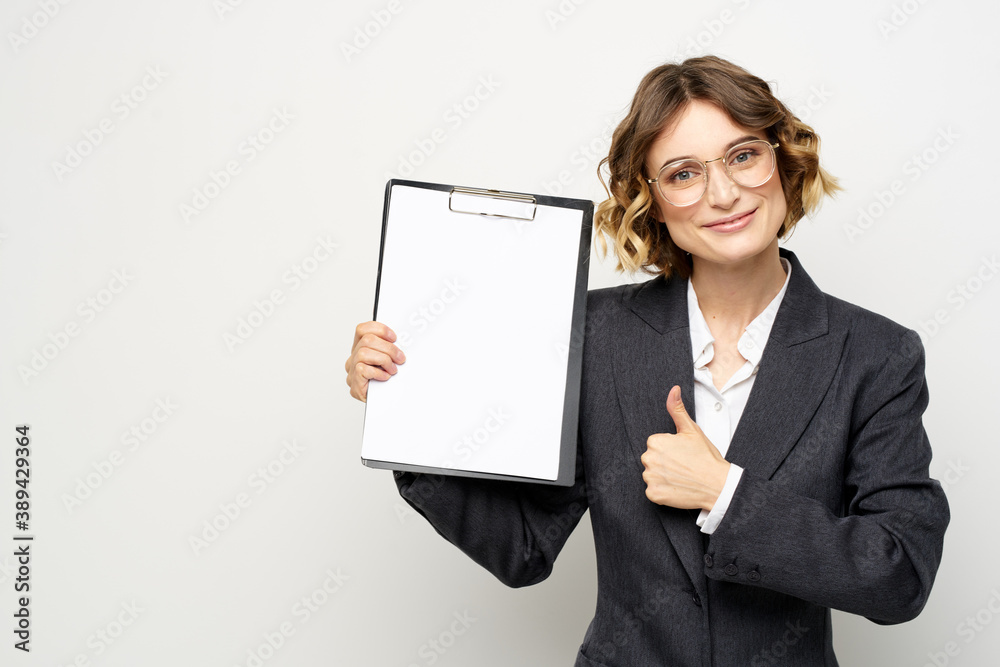 Business woman with a folder of documents on a light background cropped view and shirt suit Business woman with a folder of documents on a light background cropped view and shirt suit