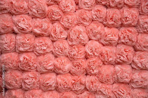 Background from pink paper flowers. Handwork. Origami