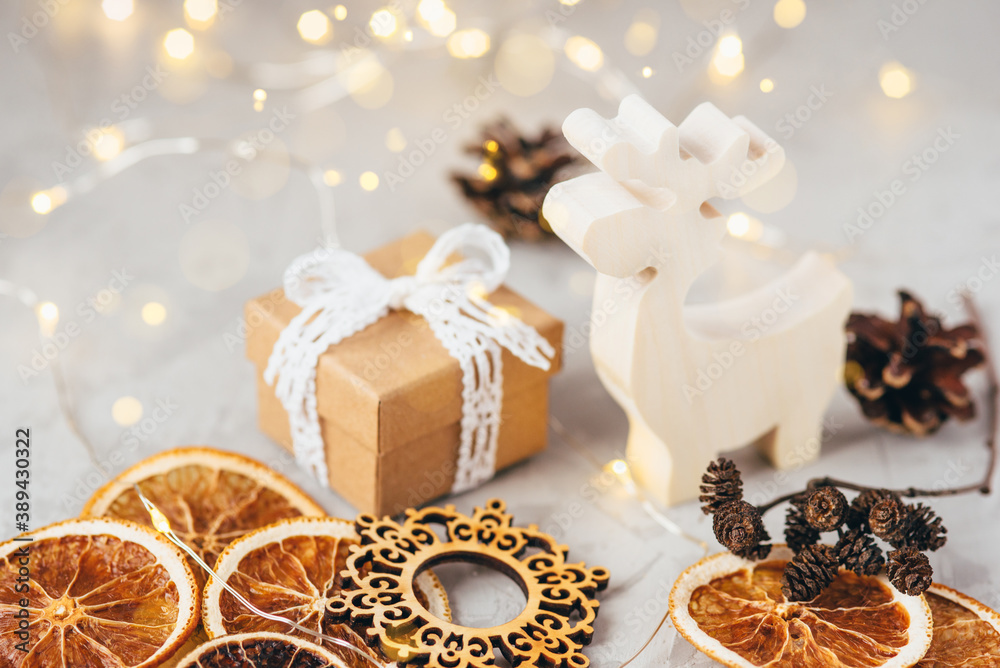 The figure of the reindeer, gift box, dry oranges and pine cone. Christmas decor, winter mood, holiday decoration. The figure of the reindeer, gift box, dry oranges and pine cone. Christmas decor, winter mood, holiday decoration.