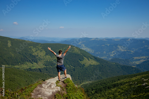 Hiker on the top in Carpathians mountains. Travel sport lifestyle concept © volody10