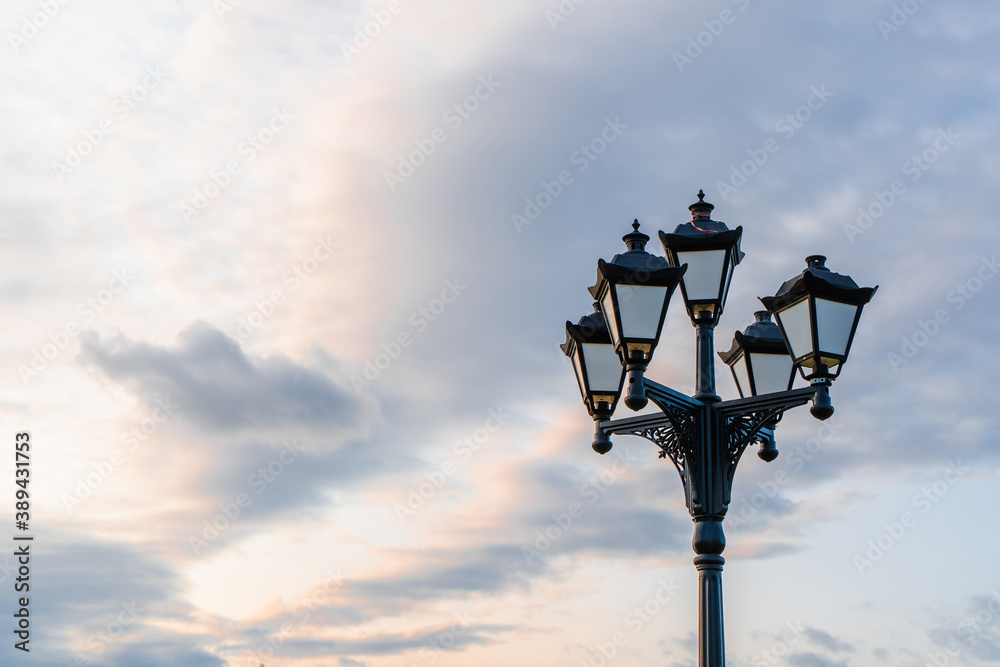 Street light with classic lamppost against a cloudy sky. Vintage style lamp post outdoors with copy space Street light with classic lamppost against a cloudy sky. Vintage style lamp post outdoors with copy space