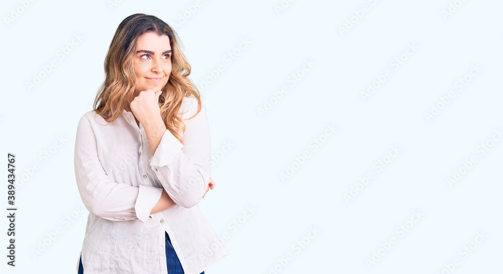 Young caucasian woman wearing casual clothes with hand on chin thinking about question, pensive expression. smiling with thoughtful face. doubt concept. Young caucasian woman wearing casual clothes with hand on chin thinking about question, pensive expression. smiling with thoughtful face. doubt concept.