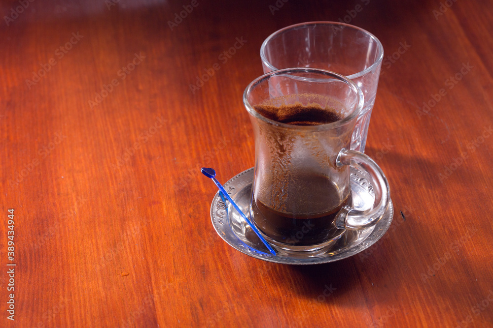 Turkish coffee and water on the wooden table. Turkish coffee and water on the wooden table.
