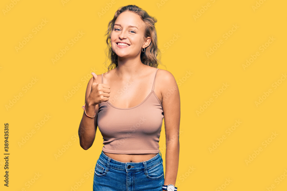Beautiful caucasian woman wearing casual clothes doing happy thumbs up gesture with hand. approving expression looking at the camera showing success. Beautiful caucasian woman wearing casual clothes doing happy thumbs up gesture with hand. approving expression looking at the camera showing success.