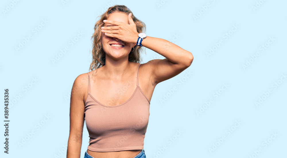 Beautiful caucasian woman wearing casual clothes smiling and laughing with hand on face covering eyes for surprise. blind concept.