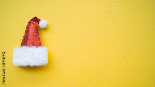 Sale and sellout concept. Single Santa Claus red hat isolated on yellow background