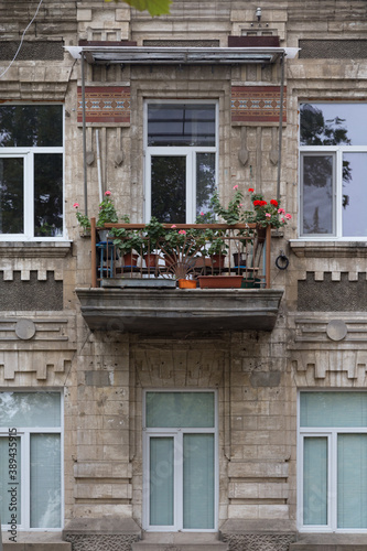 The facade with flowers on the balcony.