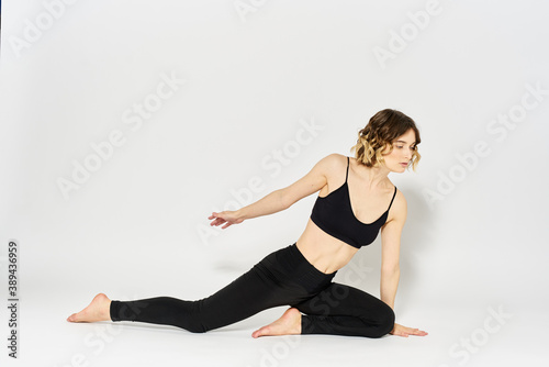 woman in dark clothes sitting on the floor and meditation exercises for legs leggings