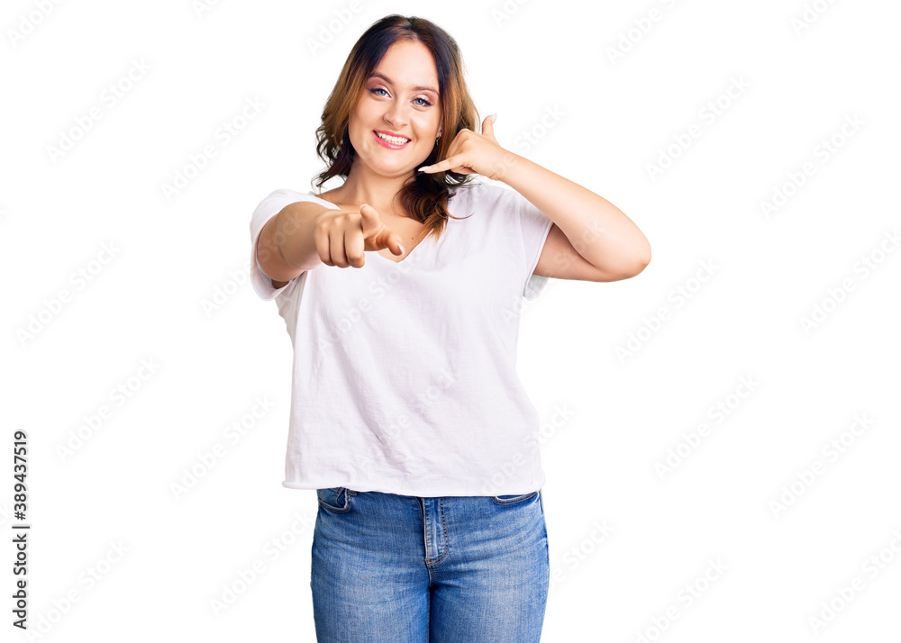 Fototapeta premium Young beautiful caucasian woman wearing casual white tshirt smiling doing talking on the telephone gesture and pointing to you. call me.