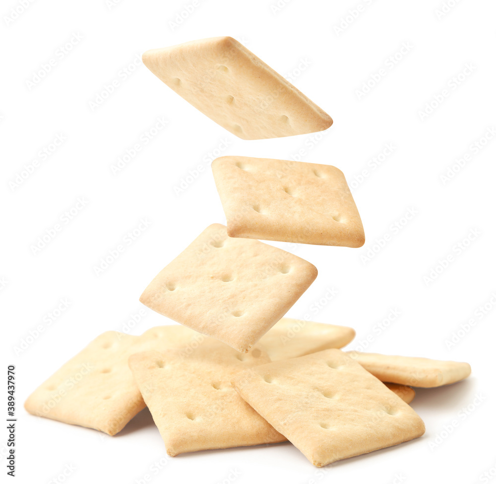 Square crackers fall on a heap on a white background. Isolated