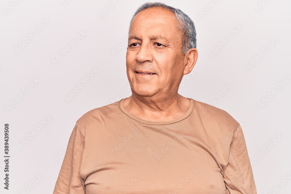 Senior man with grey hair wearing casual t-shirt looking to side, relax profile pose with natural face and confident smile. Senior man with grey hair wearing casual t-shirt looking to side, relax profile pose with natural face and confident smile.